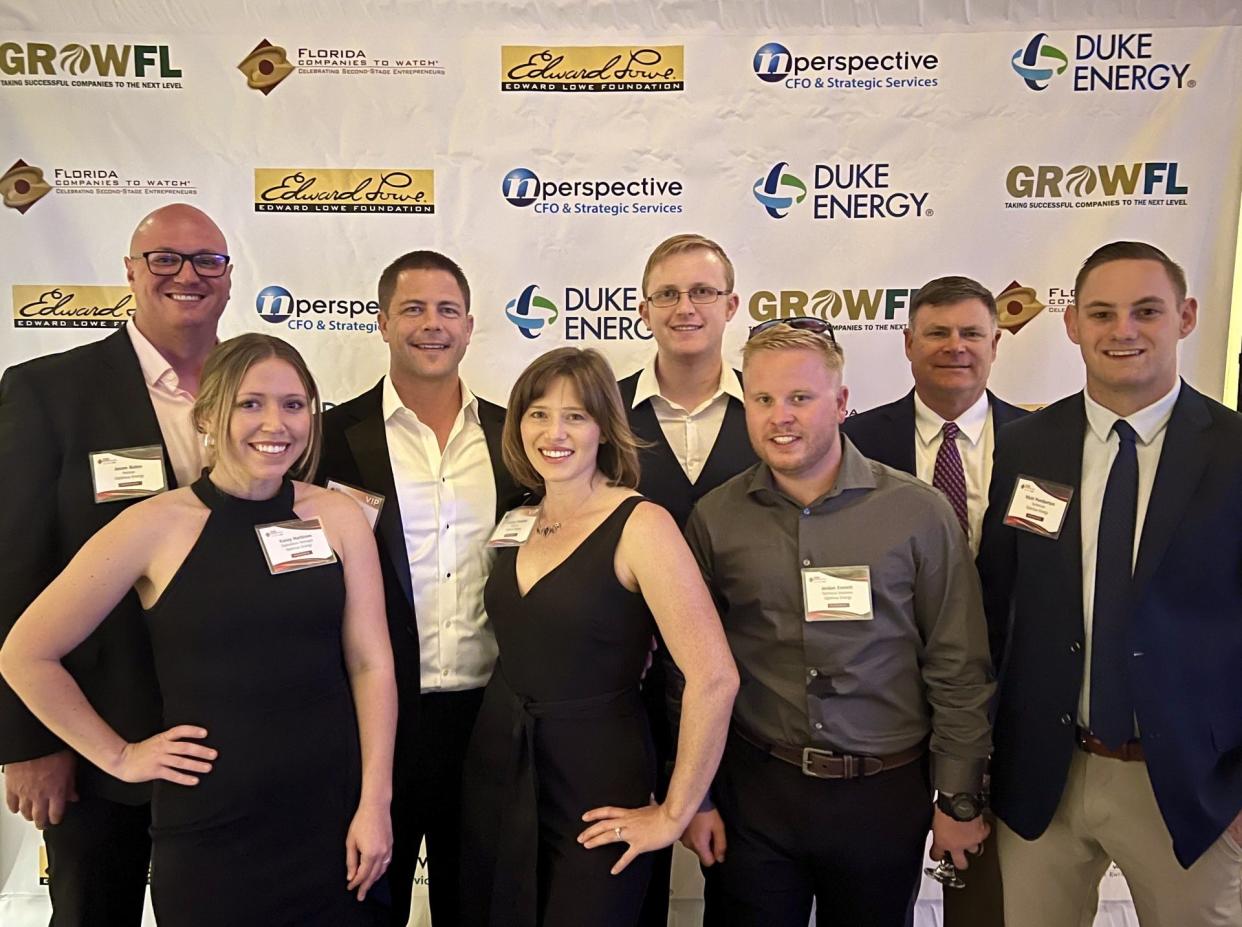 Executives from Mount Dora-based Optimus Energy Solutions pose for a red-carpet photo at the 13th annual GrowFL Awards in Orlando.