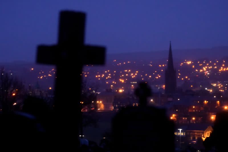 FILE PHOTO: A general view shows night falling on the city of Londonderry