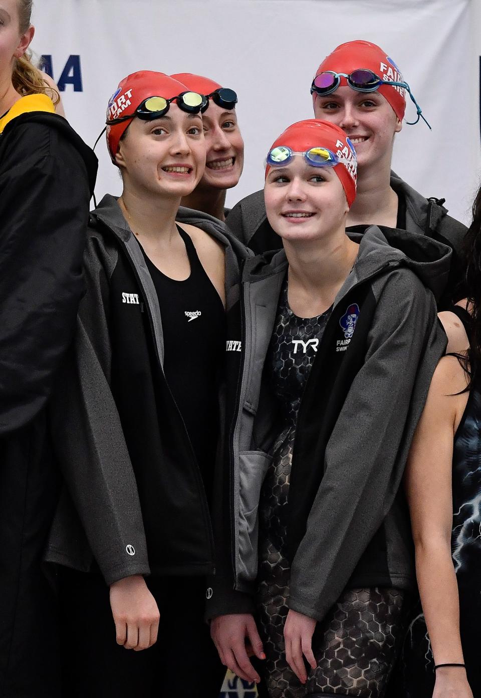Fairport's relay team poses for photos after placing fourth in the finals of the 200 yard freestyle relay during the NYSPHSAA Girls Swimming & Diving Championships, Saturday, Nov. 18, 2023.