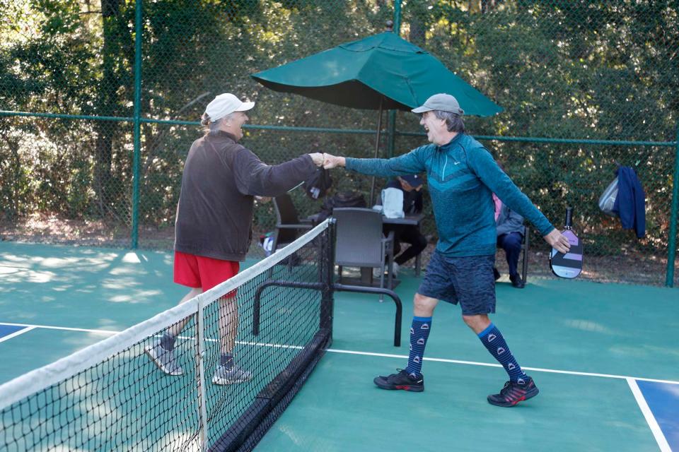 Special Pops athlete Terry Patterson fist bumps volunteer Stephen Ford during a pickleball match at The Landings Club's Franklin Creek Tennis Center on Oct. 20.