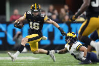 Iowa wide receiver Charlie Jones (16) runs from Michigan defensive back Brad Hawkins (2) during the first half of the Big Ten championship NCAA college football game, Saturday, Dec. 4, 2021, in Indianapolis. (AP Photo/AJ Mast)