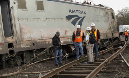 NTSB officials on the scene of the Amtrak Train #188 Derailment in Philadelphia, Pennsylvania in this handout photo provided by the National Transportation Safety Board, May 13, 2015. REUTERS/NTSB/Handout