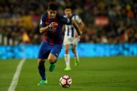 Barcelona's Luis Suarez runs with the ball during their match against Real Sociedad at the Camp Nou stadium in Barcelona on April 15, 2017