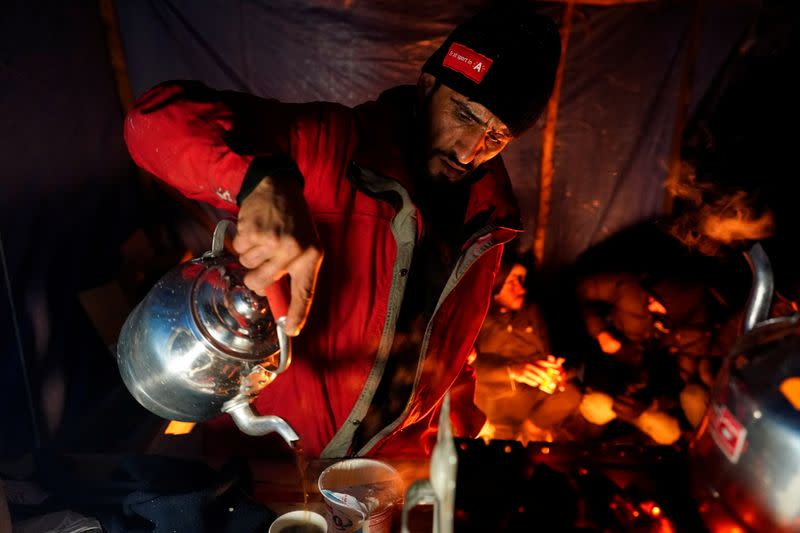 FILE PHOTO: Kurdish Iraqi migrant Dawan Anwar Mahmud sells tea at a makeshift camp in Loon-Plage near Dunkirk, France