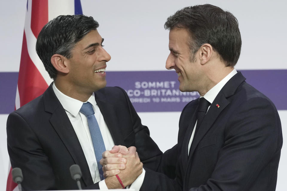 French President Emmanuel Macron, right, and Britain's Prime Minister Rishi Sunak shake hands during a joint news conference at the Elysee Palace in Paris, Friday, March 10, 2023. French President Emmanuel Macron and British Prime Minister Rishi Sunak meet Friday in Paris in a summit aimed at mending relations following post-Brexit tensions, improving military and business ties and toughening efforts against Channel migrant crossings. (AP Photo/Kin Cheung, Pool)