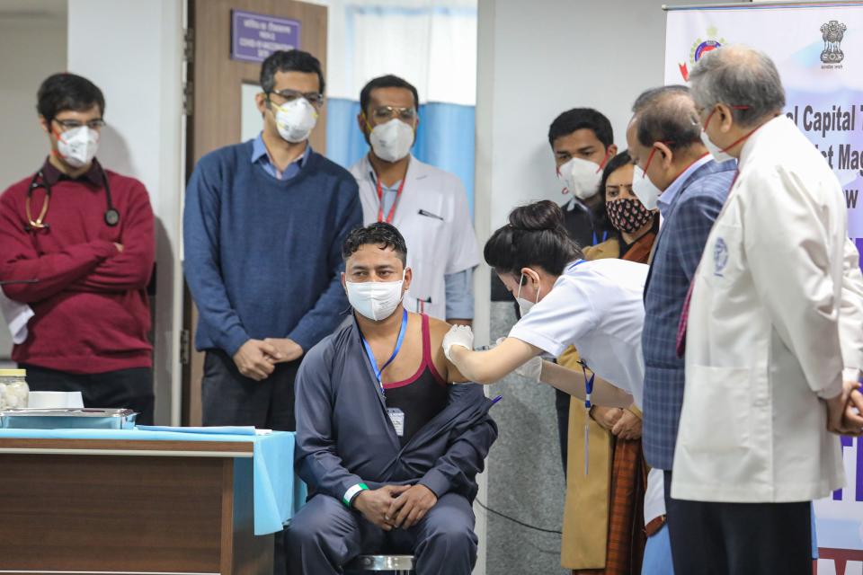 New Delhi: A medic administers the first dose of Covishield vaccine to a frontline worker in the presence of Union Health Minister Harsh Vardhan, after the virtual launch of COVID-19 vaccination drive by Prime Minister Narendra Modi, at AIIMS in New Delhi, on Saturday, 16 January 2021.