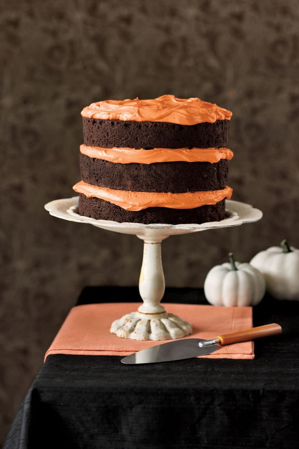 <p>In between the chocolate cake tiers, add a thick layer of orange frosting for the ultimate Halloween cake.</p><p>Get the <a href="https://www.goodhousekeeping.com/food-recipes/a5721/chocolate-pumpkin-cake-cupcakes-3922/" rel="nofollow noopener" target="_blank" data-ylk="slk:Chocolate Pumpkin Cake recipe;elm:context_link;itc:0;sec:content-canvas" class="link "><strong>Chocolate Pumpkin Cake recipe</strong></a><em>.</em></p>