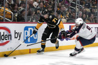 Pittsburgh Penguins' Evgeni Malkin (71) holds off Columbus Blue Jackets' Ivan Provorov (9) behind the net on a power play during the second period of an NHL hockey game in Pittsburgh, Thursday, March 28, 2024. (AP Photo/Gene J. Puskar)