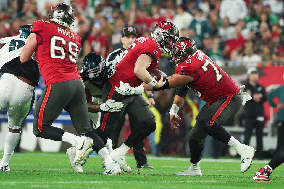 Jan 15, 2024; Tampa, Florida, USA; Tampa Bay Buccaneers quarterback Baker Mayfield (6) runs the ball as Philadelphia Eagles defensive end Josh Sweat (94) tackles during the first half of a 2024 NFC wild card game at Raymond James Stadium. Mandatory Credit: Kim Klement Neitzel-USA TODAY Sports