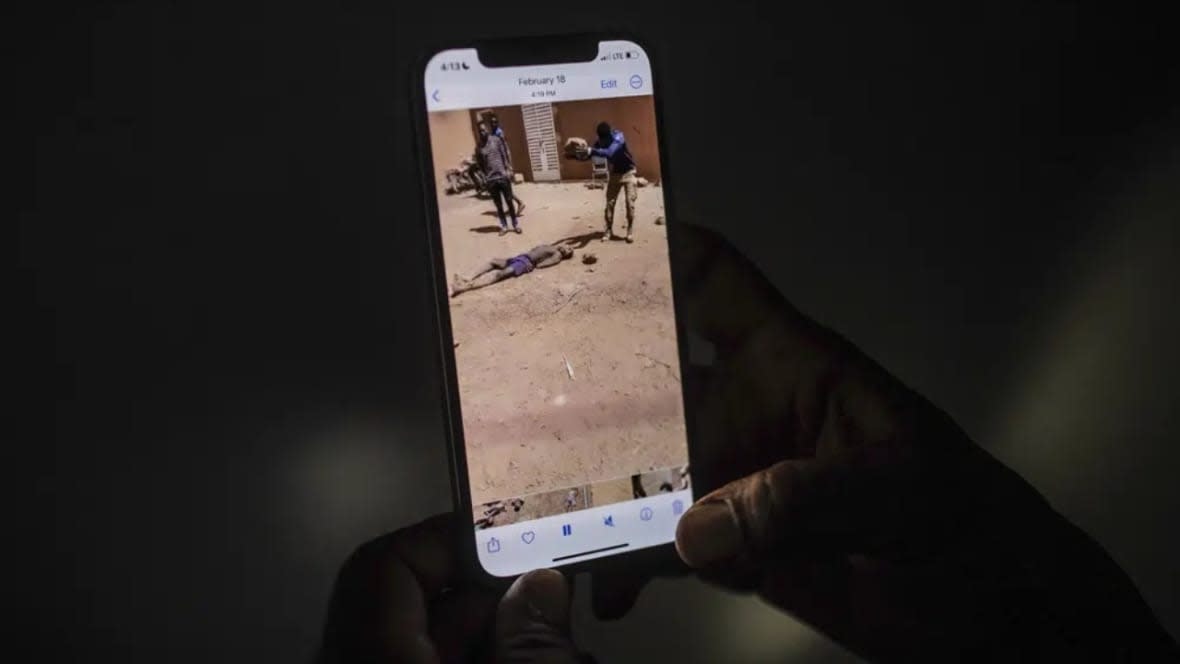 An uncle of a 16-year-old named Adama watches a video in Burkina Faso on March 18, 2023 showing a man slamming a rock onto the head of his nephew. Burkina Faso has been wracked by violence linked to al-Qaida and the Islamic State group that has killed thousands, but some civilians say they are even more afraid of Burkina Faso’s security forces, whom they accuse of extrajudicial killings. (Photo: AP)