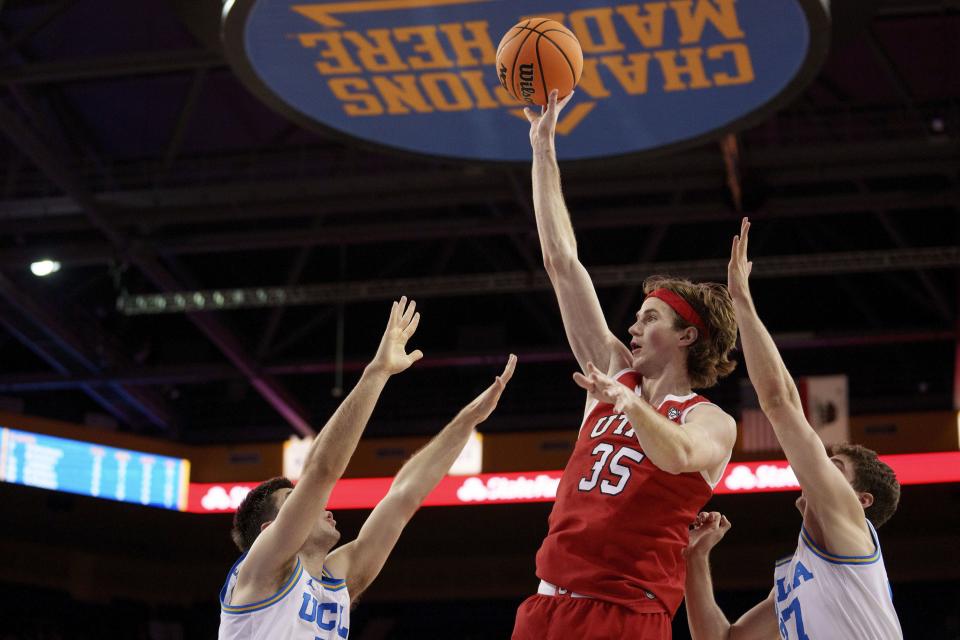 Utah center Branden Carlson (35) shoots against UCLA guards Lazar Stefanovic, left, and Jan Vide, right, during the first half of an NCAA college basketball game, Sunday, Feb. 18, 2024, in Los Angeles. | Eric Thayer, AP