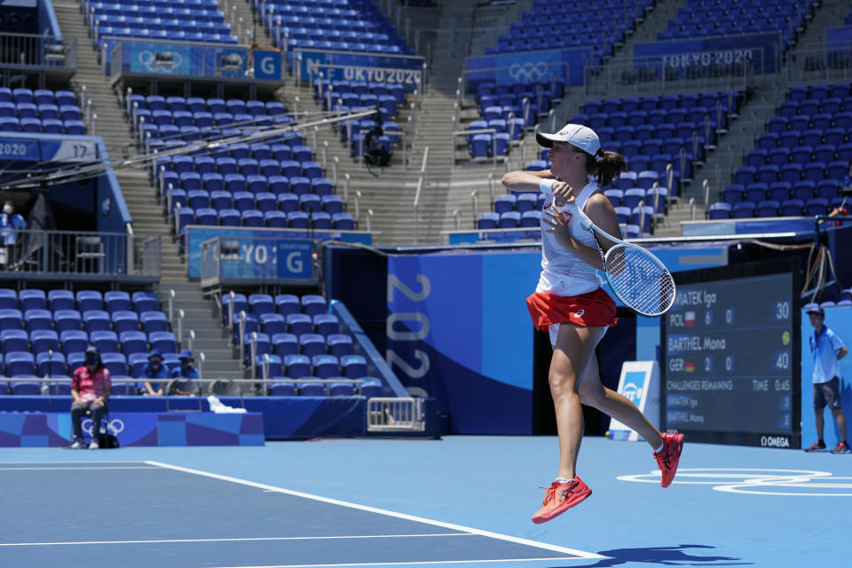 Iga Swiatek, of Poland, returns to Mona Barthel, of Germany, during the tennis competition at the 2020 Summer Olympics, Saturday, July 24, 2021, in Tokyo, Japan. (AP Photo/Patrick Semansky)