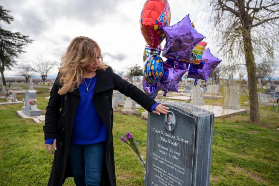Francine Turner touches the image of her son Tyler on his gravestone in Los Banos after kissing her fingers on his birthday, Feb. 25, 2023. Tyler died in 2016 while skydiving at the Parachute Center near Lodi. 