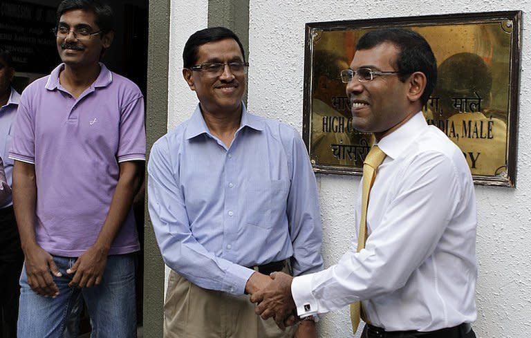 Mohamed Nasheed (right) shakes hands with Indian High Commissioner DM Mulay in Male today. Nasheed sought refuge at the embassy on February 13, straining ties between India and its tiny neighbour, following an arrest warrant that was issued after he failed to attend court for what he called a 'politically motivated' trial