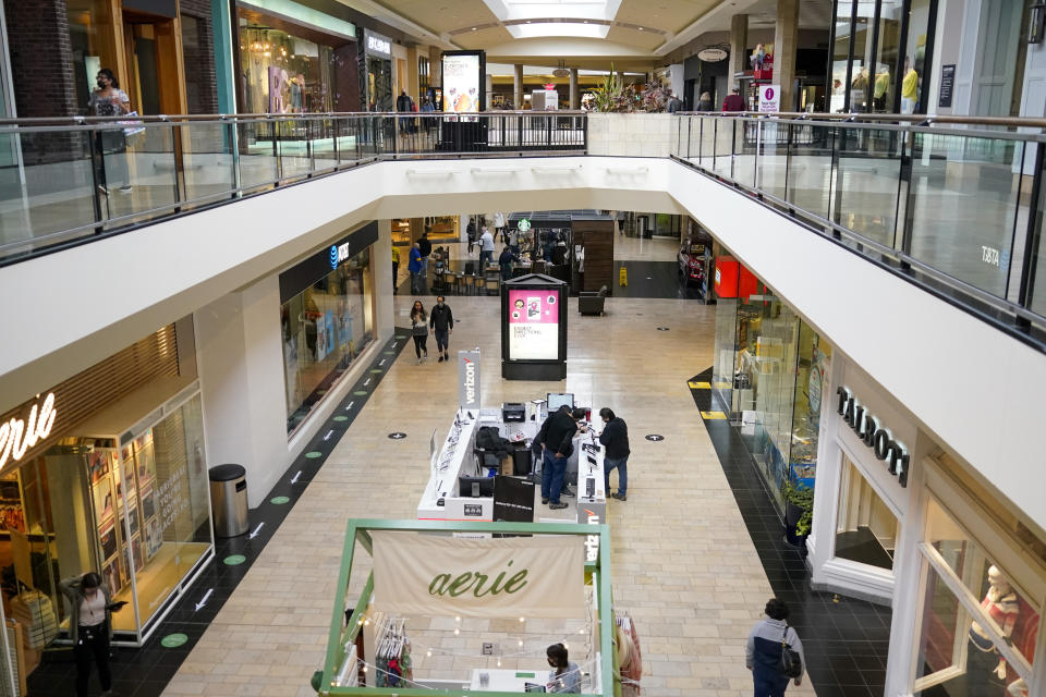 In this photo made on Wednesday, Feb. 24, 2021, people walks through a shopping mall in Pittsburgh. (AP Photo/Keith Srakocic)