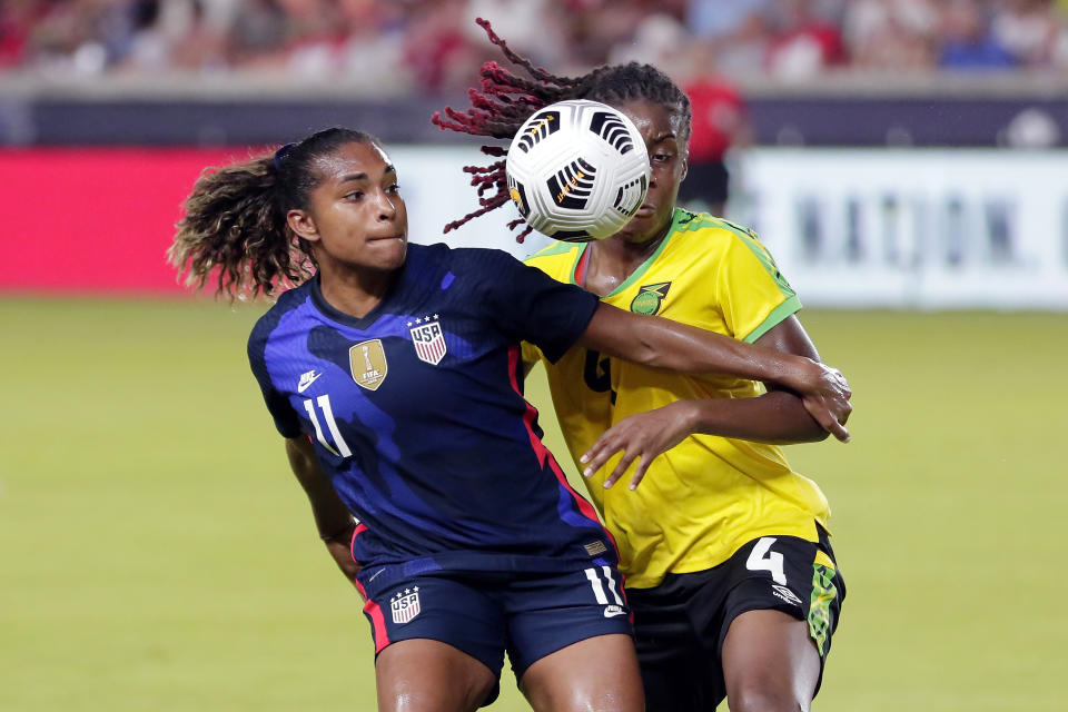 U.S. forward Catarina Macario (11) holds back Jamaica midfielder Vyan Sampson (4) during the first half of their 2021 WNT Summer Series soccer match, Sunday, June 13, 2021, in Houston. (AP Photo/Michael Wyke)