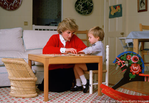 In this October 1985 photo, Princess Diana and Prince William, age 3, work on a puzzle together at home at Kensington Palace.