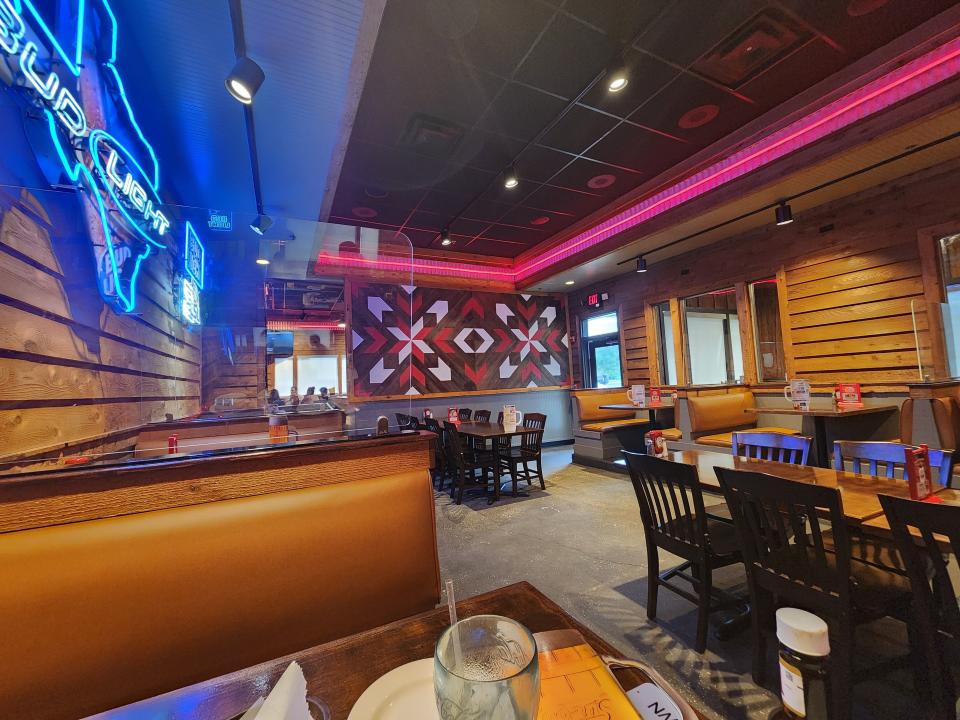 Interior of Logan's Roadhouse with neon signs