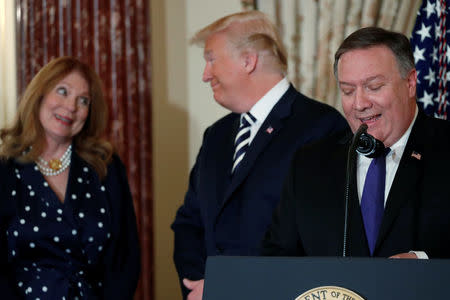 U.S. President Donald Trump (C) shares a glance with incoming Secretary of State Mike Pompeo's wife Susan at Pompeo's ceremonial swearing-in at the State Department in Washington, U.S. May 2, 2018. REUTERS/Jonathan Ernst
