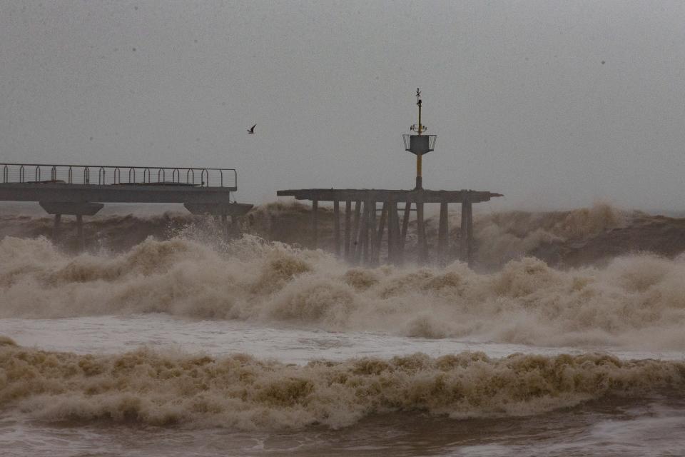 Waves hit a partially damage bridge during a storm in Badalona's beach, outskirts of Barcelona, Spain, Wednesday, Jan. 22, 2020. Massive waves and gale-force winds smashed into seafront towns, damaging many shops and restaurants and flooding some streets. (AP Photo/Joan Mateu)