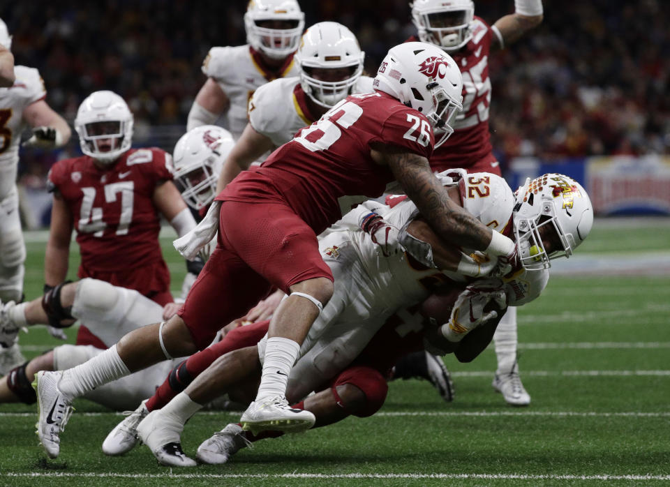 Iowa State running back David Montgomery (32) is hit by Washington State defensive back Hunter Dale (26) and another defender, partially obscure, during the second half of the Alamo Bowl NCAA college football game Friday, Dec. 28, 2018, in San Antonio. (AP Photo/Eric Gay)