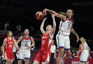 Japan's Saori Miyazaki (32), center, is blocked by United States' Brittney Griner (15), second right, during women's basketball preliminary round game at the 2020 Summer Olympics, Friday, July 30, 2021, in Saitama, Japan. (AP Photo/Eric Gay)