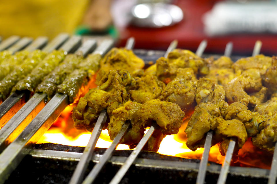 ground chicken and lamb kebabs on stick over grill