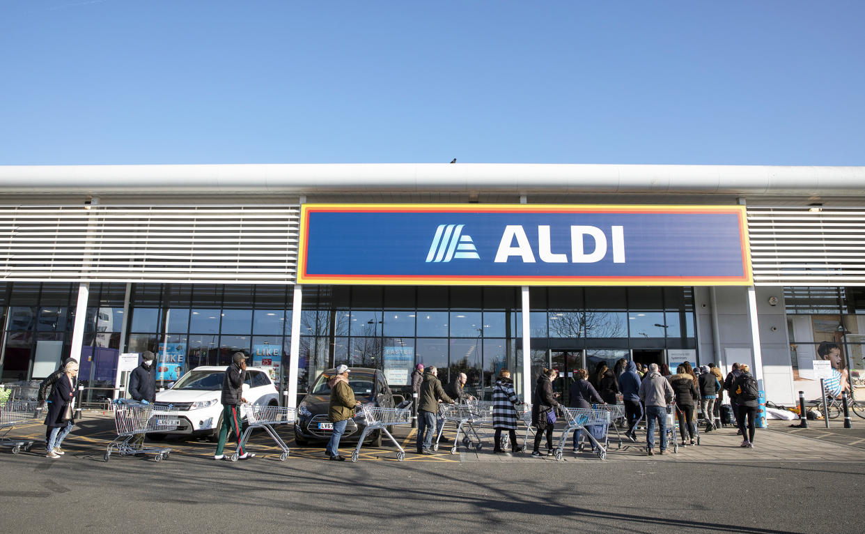 Shoppers queue outside an Aldi supermarket (Dan Kitwood / Getty Images)