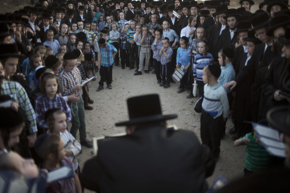 Men listen to their rabbi