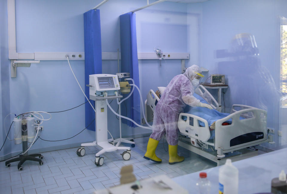 A nurse inside the Intensive Care Unit attends to a patient with COVID-19 in the Clinic for Infectious Diseases during the ongoing Coronavirus pandemic, in Pristina, Kosovo, Monday, Sept. 21, 2020. Political pressure is growing in Europe for governments to tackle the rising number of coronavirus case without resorting to a spring-style lockdown that would hit the continent's struggling economies. (AP Photo/Visar Kryeziu)