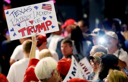 A supporter of Republican U.S. Presidential candidate Donald Trump holds up a sign at a campaign rally at Gilley's Dallas in Dallas, Texas, U.S., June 16, 2016. REUTERS/Brandon Wade