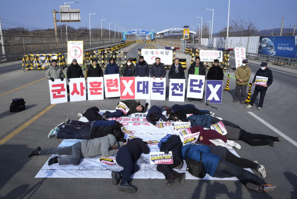 South Korean activists stage a die-in during a rally to demand the peace on the Korean peninsula near the Unification Bridge, which leads to the Panmunjom in the Demilitarized Zone in Paju, South Korea, Friday, Feb. 2, 2024. South Korea's military said it detected North Korea firing multiple cruise missiles into waters off its western coast Friday, adding to a provocative run of weapons testing in the face of deepening tensions with the United States, South Korea and Japan. (AP Photo/Ahn Young-joon)