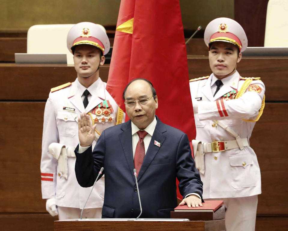 Vietnamese newly elected President Nguyen Xuan Phuc takes an oath in front of the National Assembly in Hanoi, Vietnam on Monday, April 5, 2021. Vietnam's legislature voted Monday to make Pham Minh Chinh, a member of the Communist party's central committee for personnel and organization, the country's next prime minister. Outgoing Prime Minister Nguyen Xuan Phuc was appointed the new president. (Nguyen Trong Duc/VNA via AP)