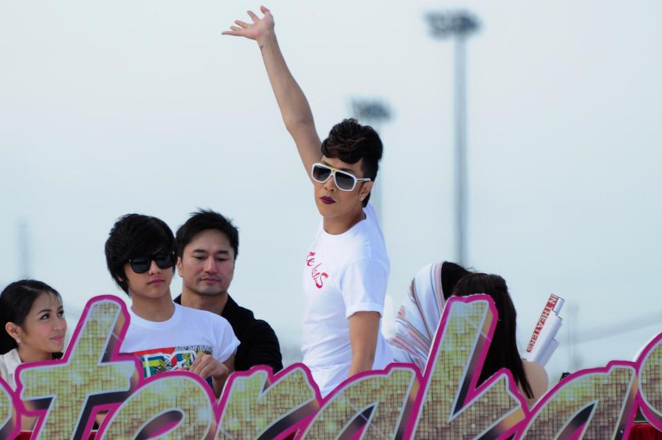 Vice Ganda waves to the crowd as the float of the MMFF 2012 entry "Sisterekas" makes its way at the 2012 Metro Manila Film Festival Parade of Stars on 23 December 2012. (Angela Galia/NPPA images)