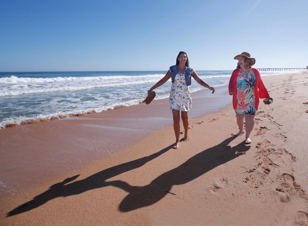 Tracy Miley, left, with her friend Dawn Fowler who she donated a kidney walk on Flagler Beach, Thursday, Dec. 8, 2022.