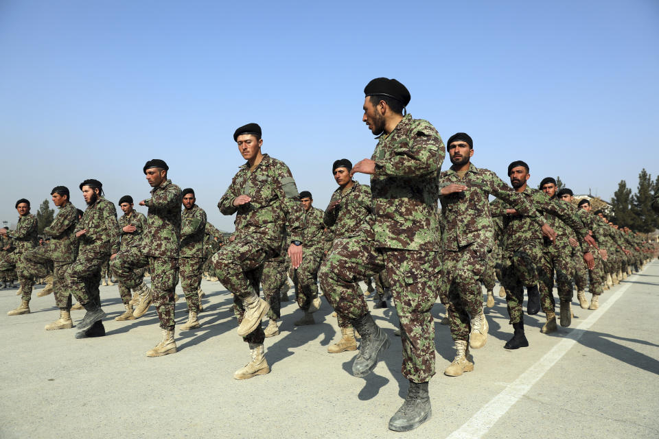 FILE - In this Jan. 18, 2021, file photo newly graduated Afghan National Army march during their graduation ceremony after a three-month training program at the Afghan Military Academy in Kabul, Afghanistan. America’s longest war is approaching a crossroads. President Joe Biden’s choices in Afghanistan boil down to this: withdraw all troops by May and risk a resurgence of extremist dangers, or stay and possibly prolong the war in hopes of compelling the Taliban to make peace. (AP Photo/Rahmat Gul)