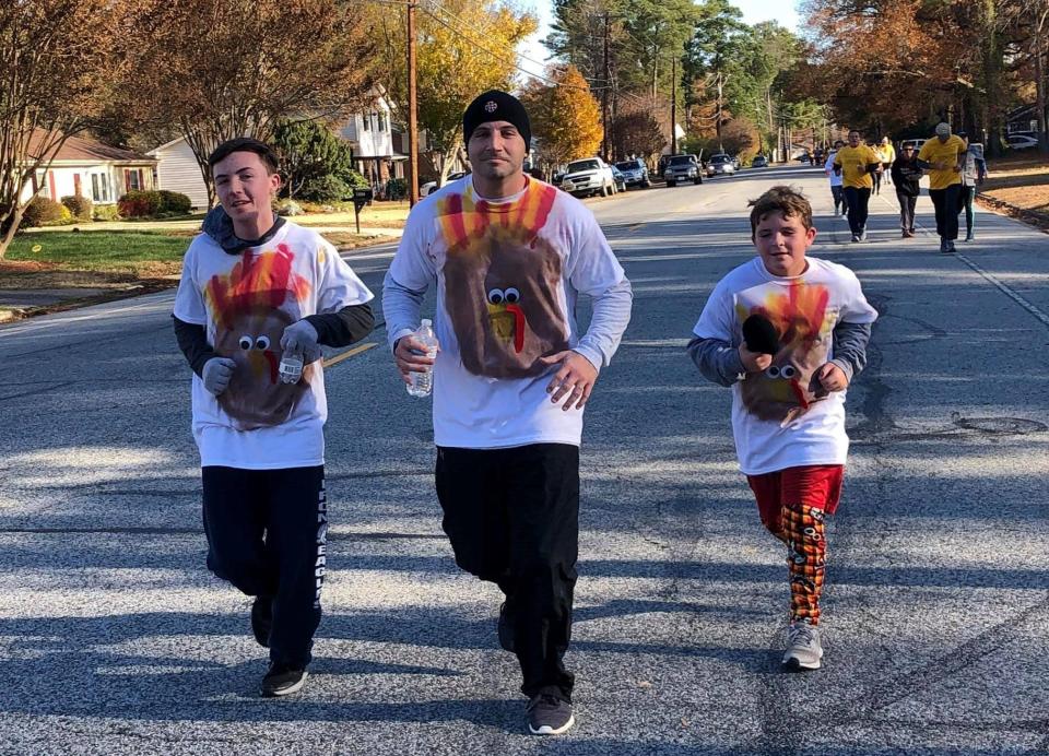 Sporting t-shirts they designed themselves, the Miller family runs in the 8th annual Turkey Trot on Thanksgiving morning in Colonial Heights.