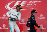 <p>Formula One F1 – Japanese Grand Prix 2017 – Suzuka Circuit, Japan – October 8, 2017. Mercedes’ Lewis Hamilton of Britain celebrates winning the race next to Red Bull’s Max Verstappen of the Netherlands. REUTERS/Toru Hanai</p>