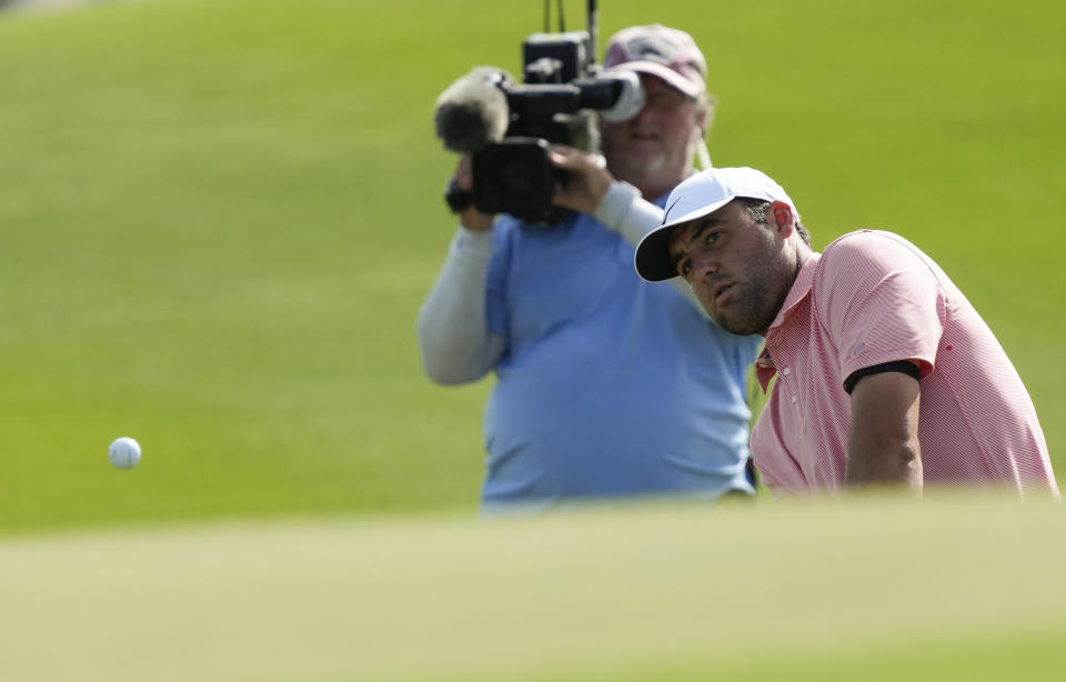 Scottie Scheffler, of the United States, chips onto the third green during the final round of the Hero World Challenge PGA Tour at the Albany Golf Club, in New Providence, Bahamas, Sunday, Dec. 4, 2022. (AP Photo/Fernando Llano)