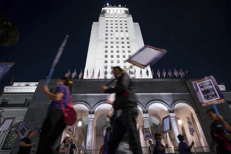 Los Angeles city employees with SEIU Local 721 picket outside of City Hall in Los Angeles on Tuesday, Aug. 8, 2023. Thousands of Los Angeles city employees, including sanitation workers, engineers and traffic officers, walked off the job for a 24-hour strike alleging unfair labor practices. The union said its members voted to authorize the walkout because the city has failed to bargain in good faith and also engaged in labor practices that restricted employee and union rights. (David Crane/The Orange County Register via AP)