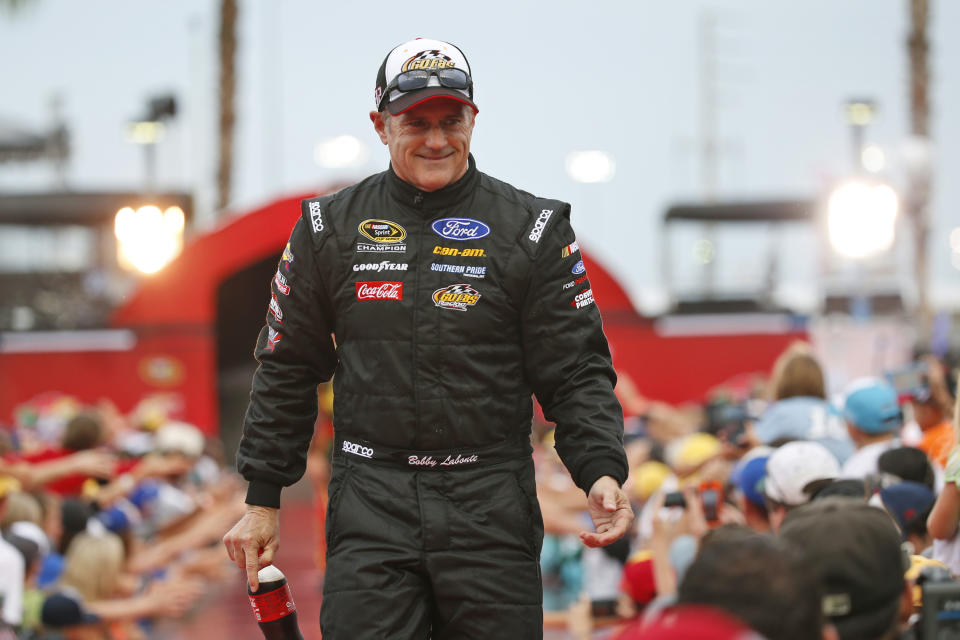 FILE - Bobby Labonte is greeted by fans during driver introductions before the start of the NASCAR Sprint Cup auto race at Daytona International Speedway in Daytona Beach, Fla., in this Saturday, July 2, 2016, file photo. Superstar Racing Experience (SRX) will be a completely new experience for most of the 12-driver field, which at Stafford Speedway in Connecticut will feature NASCAR Hall of Famer's Stewart, Bill Elliott and Bobby Labonte, as well as Greg Biffle, Michael Waltrip, Willy T. Ribbs, and Indianapolis 500 winner Tony Kanaan, Paul Tracy and Marco Andretti, as well as Ernie Francis Jr., an accomplished road racer who at 23 is the youngest driver in the field. (AP Photo/Wilfredo Lee, File)