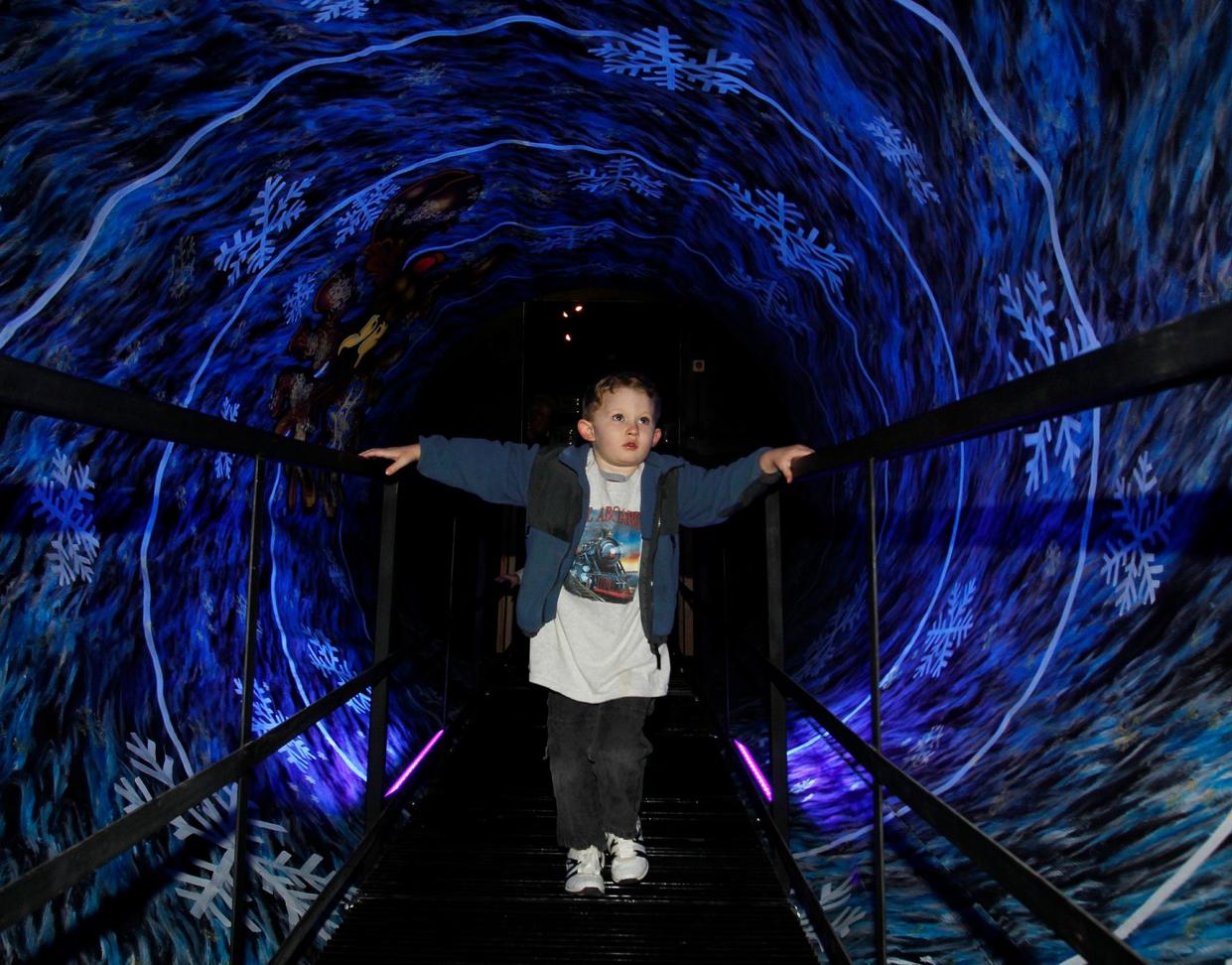 A guest walks through the twirling Blizzard Vortex tunnel in Castle Noel, a Christmas themed museum in Medina, Ohio, that has authentic props and sets from Hollywood Christmas movies, as well as former window displays from New York City department stores.