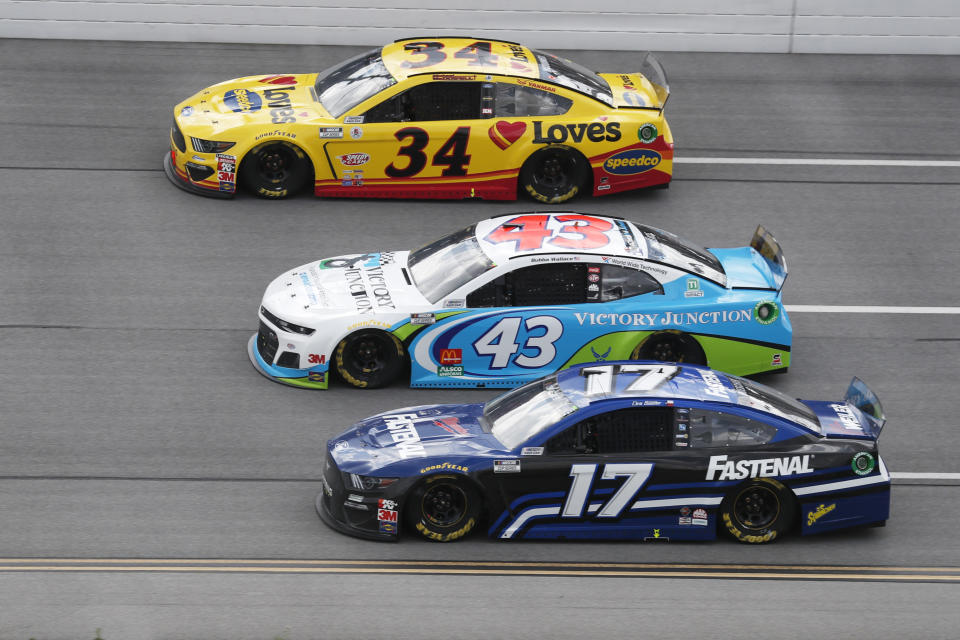Michael McDowell (34), Bubba Wallace (43) and Chris Buescher (17) ride side-by-side during a NASCAR Cup Series auto race at Talladega Superspeedway in Talladega Ala., Monday, June 22, 2020. (AP Photo/John Bazemore)