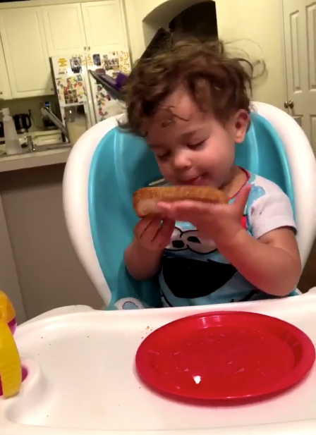 Maya starts the video obsessed with the peanut butter on her bread. Photo: Twitter