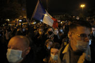 People attend a memorial march in homage to the history teacher who was beheaded last week, Tuesday, Oct.20, 2020 in Conflans-Sainte-Honorine, northwest of Paris. Samuel Paty was beheaded on Friday by an 18-year-old Moscow-born Chechen refugee, who was later shot dead by police. Police officials said Paty had discussed caricatures of Islam's Prophet Muhammad with his class, leading to threats. (AP Photo/Lewis Joly)