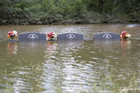 The floodwaters recede from Bethel United Methodist Cemetery in Greenwell Springs, Louisiana. REUTERS/Jeffrey Dubinsky