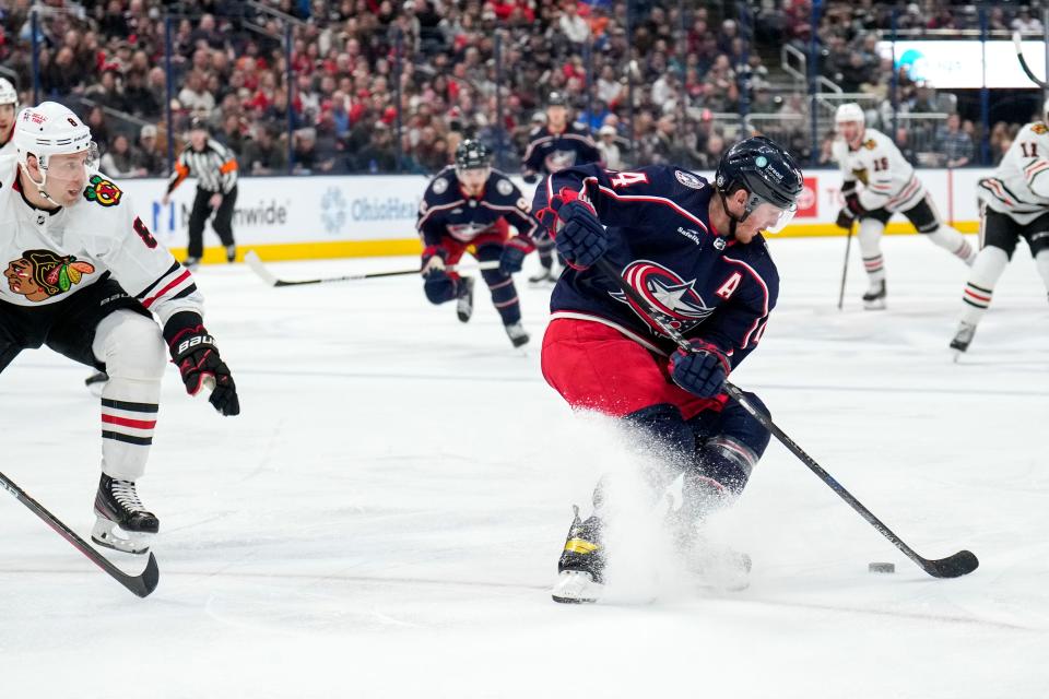 Blue Jackets left wing Gustav Nyquist spins around to dodge Chicago defenseman Jack Johnson.