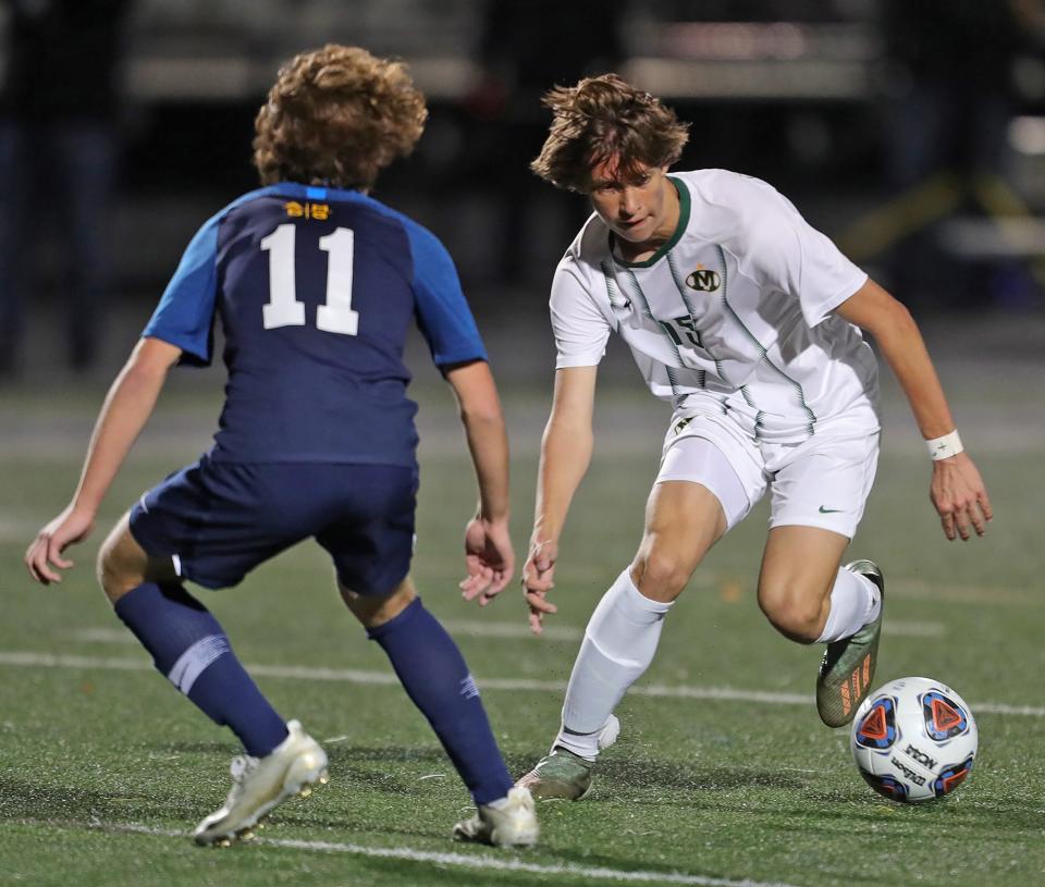 Medina's Cole Turchyn, right, takes the ball downfield against Luciano Pechota of St. Ignatius during the first half of a Division I state semifinal soccer game, Wednesday, Nov. 11, 2020, in Brunswick, Ohio. [Jeff Lange/Akron Beacon Journal]
