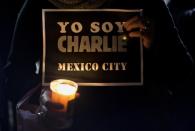 A woman holds a sign reading 'Yo soy Charlie' (I am Charlie) on January 8, 2015 in front of the French embassy in Mexico City in support of the victims of the terrorist attack at the French magazine Charlie Hebdo