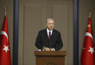 Turkey's President Recep Tayyip Erdogan, talks during a news conference in Ankara, Turkey, Monday Oct. 7, 2019 prior to his departure for Serbia for an official visit. Erdogan says American troops have started withdrawing from positions in northern Syria, hours after the White House said that U.S. forces in northeast Syria will move aside and clear the way for an expected Turkish incursion. (Presidential Press Service via AP, Pool)